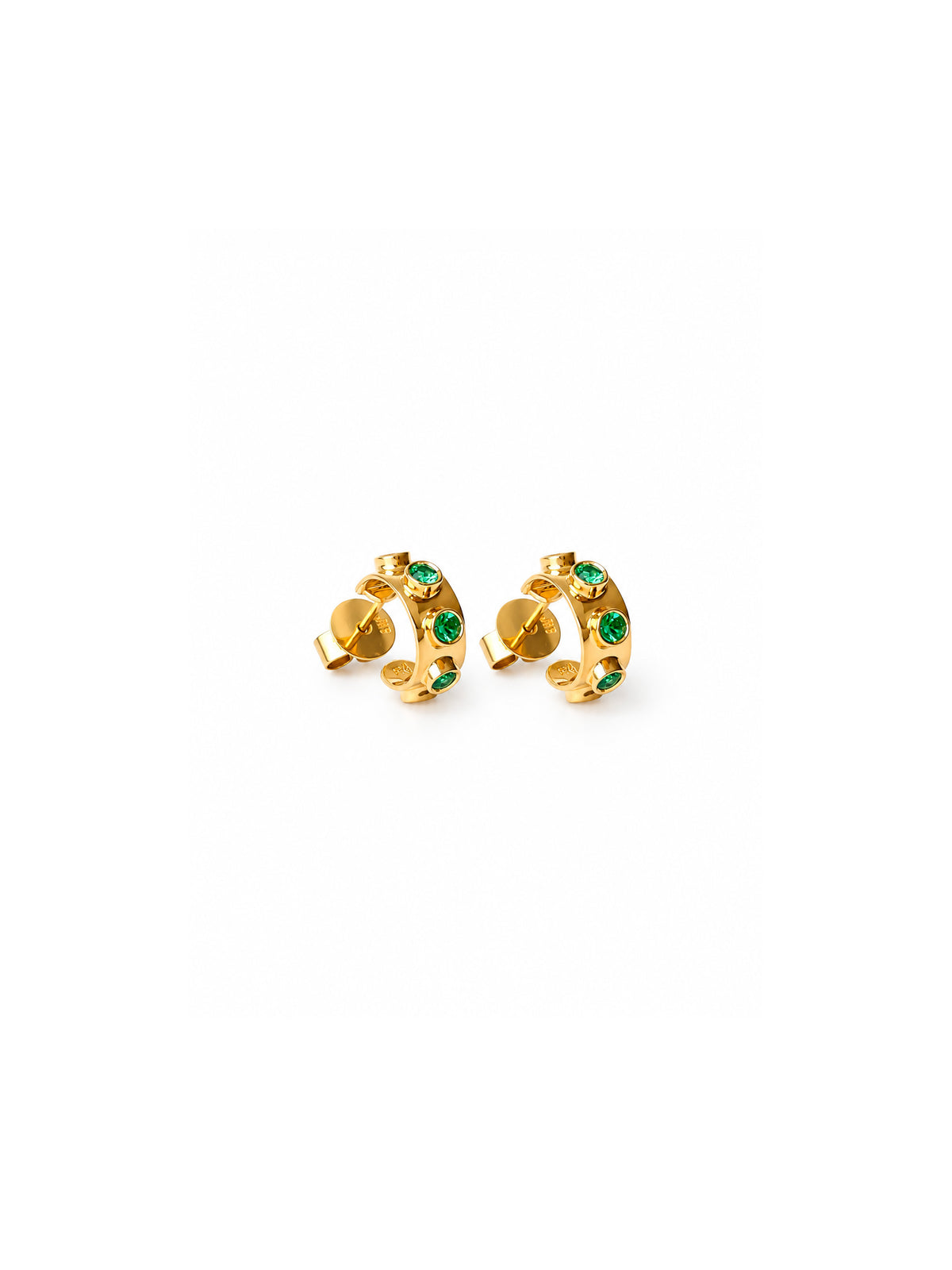 A pair of gold huggie hoop earrings with small green gemstone accents, shown on a plain white background.