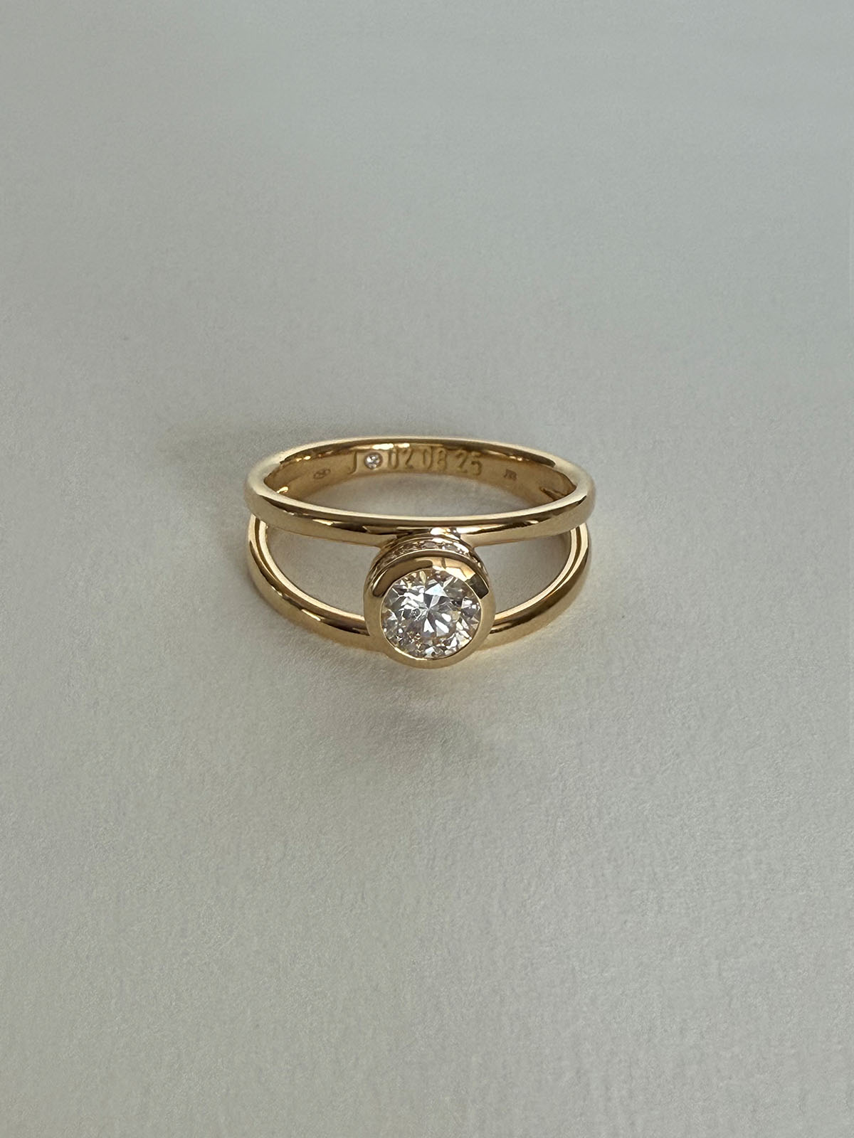 Trine - Ring with a 0.53 carat center diamond surrounded with halo brilliant-cut diamonds