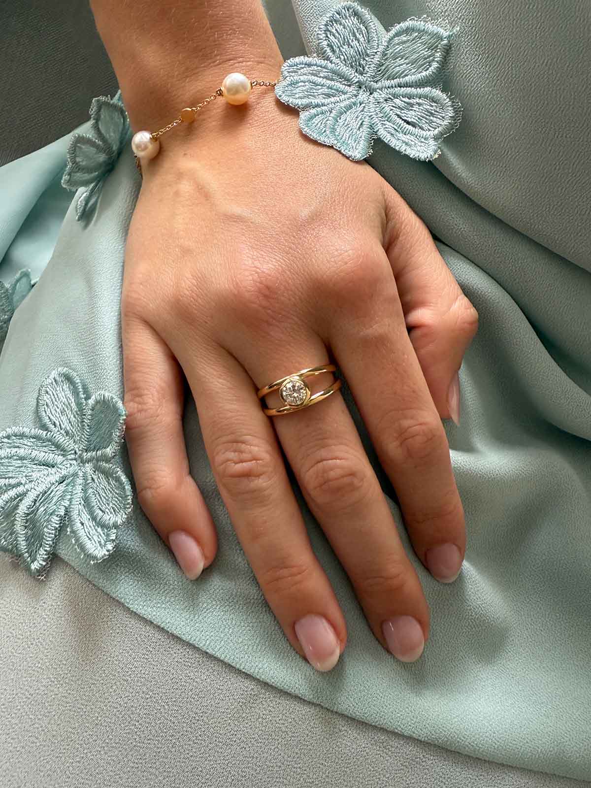Trine - Ring with a 0.53 carat center diamond surrounded with halo brilliant-cut diamonds