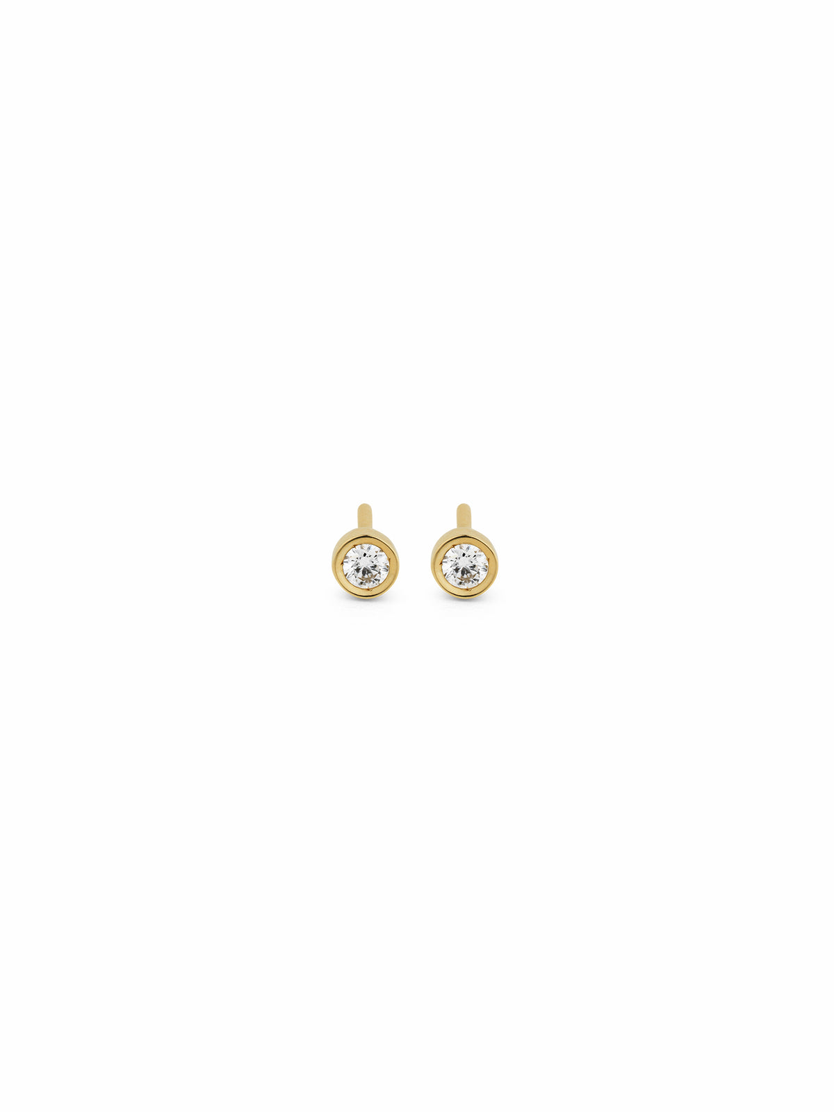 A pair of gold stud earrings with round bezel-set clear gemstones, displayed on a solid white background.