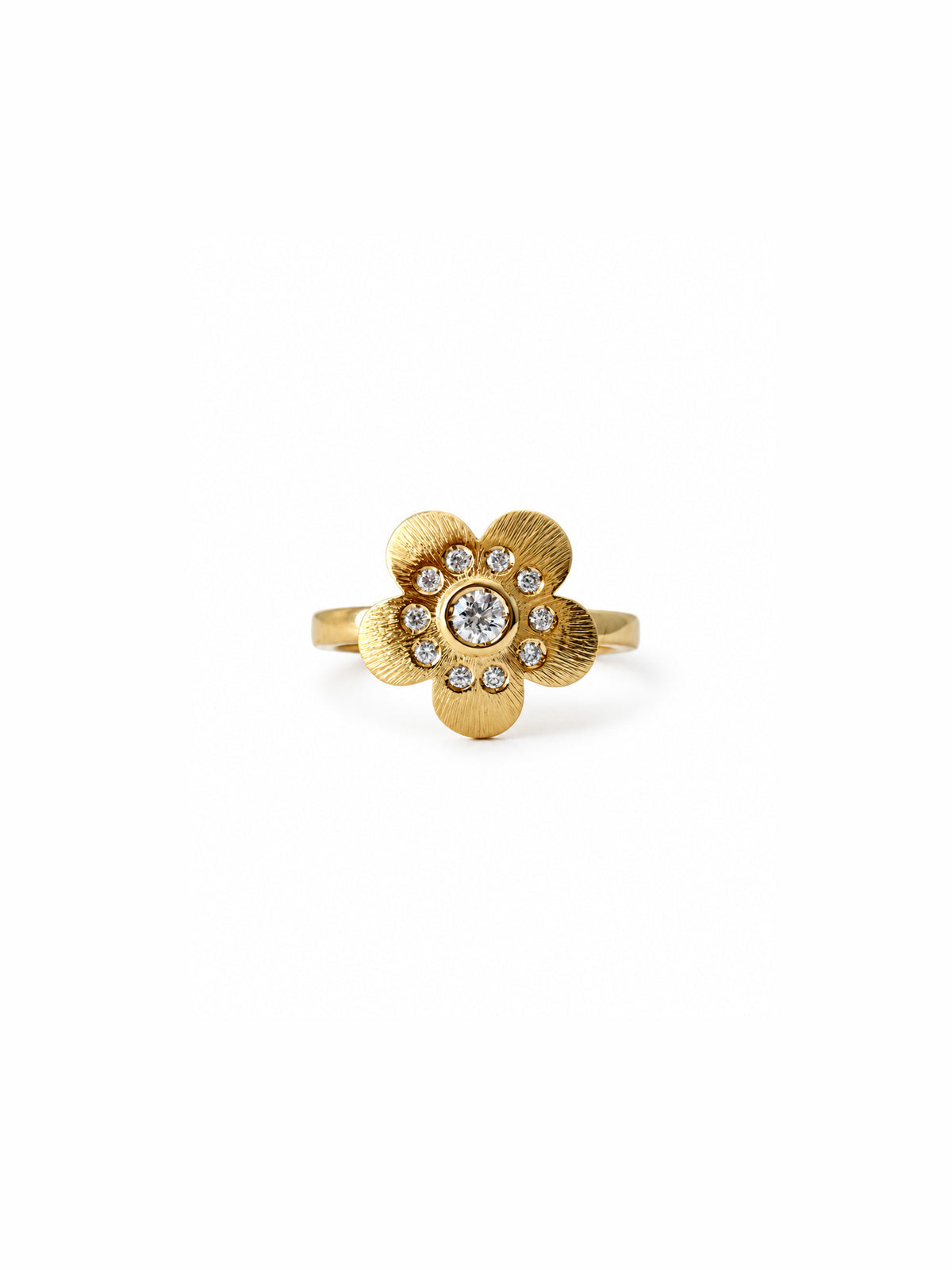 Crafted in 18-karat gold and set with a brilliant white diamond, the flower is slightly elevated above the ring, giving it an almost floating, sculptural expression. Soft in shape, strong in presence, with just the right balance of femininity, attitude and sparkle.