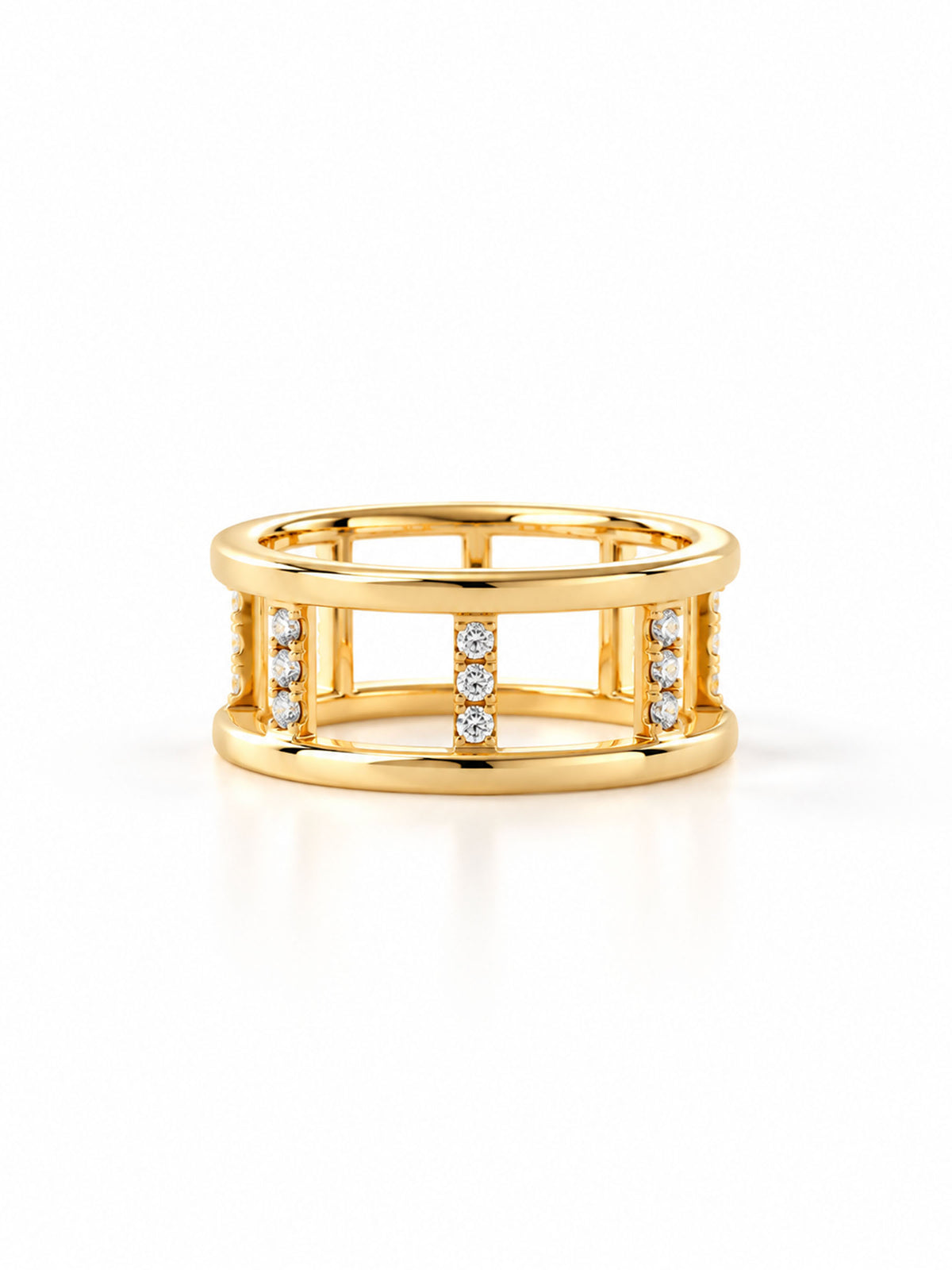 A gold ring with a geometric openwork design, featuring three vertical bars set with small clear stones, shown on a clean white background.